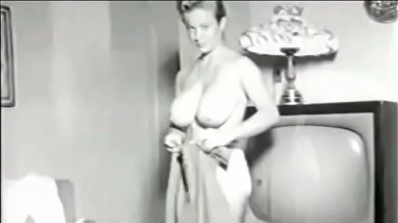 Vintage busty beauty bends over bends over TV showing her big tight breasts for you